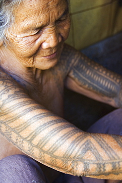 Old woman with traditional tattoo on arms in local home, Liglig Headhunters Village, Tinglayan Town, The Cordillera Mountains, Kalinga Province, Luzon, Philippines, Southeast Asia, Asia