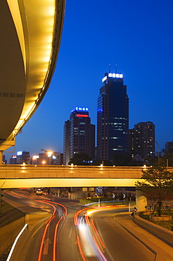 Car light trails and modern buildings near Beijing North Train Station, Xizhimen district, Beijing, China, Asia