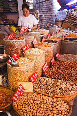 Vendor selling nuts at a market in the Muslim Quarter, home to the city's Hui community, Xian City, Shaanxi Province, China, Asia