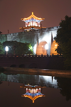 City wall and watch tower reflected in water, built during the first reign of Hongwu the first emperor of the Ming dynasty, Xian City, Shaanxi Province, China, Asia