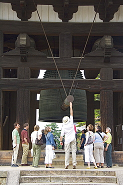 Tourists look at big cast iron bell, Todaiji (Big Buddha) Temple, constructed in the 8th century Nara City, Nara Prefecture, Honshu Island, Japan, Asia 