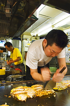 Okonomiyaki Japanese pancake being made at Fast Food Outlet at Okonomimura, Hiroshima City, Hiroshima prefecture, Honshu Island, Japan, Asia