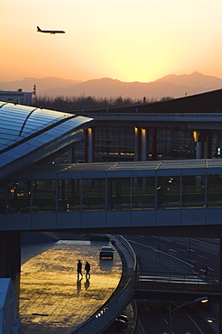 A plane coming in to land at Beijing Capital Airport, part of new Terminal 3 building opened February 2008, second largest building in the world, Beijing, China, Asia