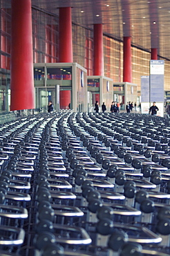 Hundreds of trolleys at Beijing Capital Airport, part of the new Terminal 3 building opened February 2008, second largest building in the world, Beijing, China, Asia