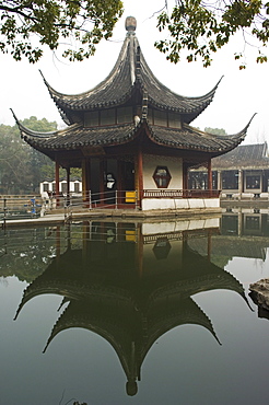 A pagoda reflected in the water at West Garden Buddhist Temple, Suzhou, Jiangsu Province, China, Asia