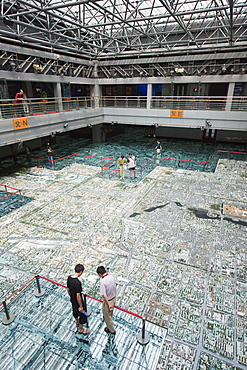 Visitors looking at a scale model of city buildings at the Beijing Planning and Exhibition Hall, Beijing, China, Asia