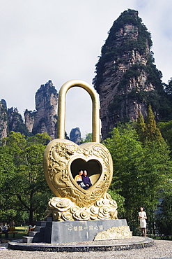 A couple in a giant love heart lock, Zhangjiajie Forest Park, Wulingyuan Scenic Area, UNESCO World Heritage Site, Hunan Province, China, Asia