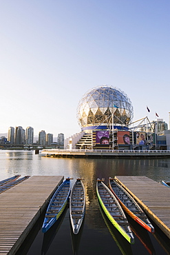 Colourful rowing boats in front of Telus Science World, on False Creek, Vancouver, British Columbia, Canada, North America