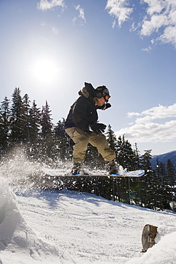 A snowboarder jumping at Whistler mountain resort, venue of the 2010 Winter Olympic Games, British Columbia, Canada, North America