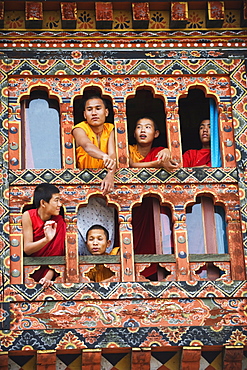 Young monks at a window, Chimi Lhakhang dating from 1499, Temple of the Divine Madman Lama Drukpa Kunley, Punakha, Bhutan, Asia