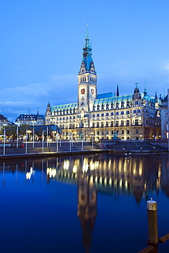 Rathaus (City Hall) illuminated at night reflected in a canal, Hamburg, Germany, Europe