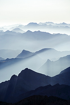 Mountains silhouetted at sunrise, view from Pico de Aneto, at 3404m the highest peak in the Pyrenees, Spain, Europe