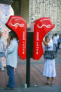 People calling from a telephone booth, Medellin, Colombia, South America