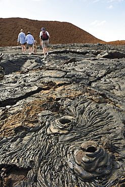 Tourists walking on lava flow on Isla Santiago, Sullivan Bay, Galapagos Islands, UNESCO World Heritage Site, Ecuador, South America