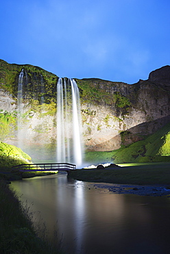 Seljalandsfoss waterfall lit up at night, Southern Region, Iceland, Polar Regions