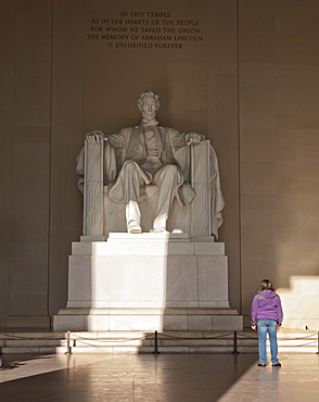 The statue of Lincoln in the Lincoln Memorial being admired by a young girl, Washington D.C., United States of America, North America