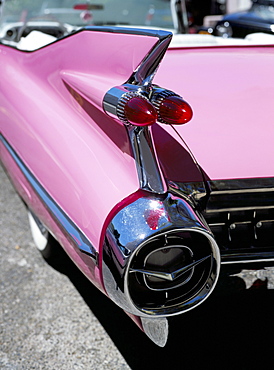 Close-up of fin and lights on a pink Cadillac car