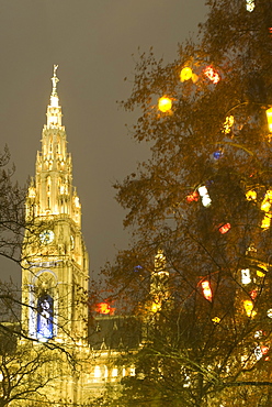 Tree decorated with lit Christmas presents and Rathaus (Town Hall) tower at Rathausplatz at twilight, Innere Stadt, Vienna, Austria, Europe