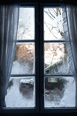 View of Bad Tolz spa town covered by snow at sunrise from window, Bavaria, Germany, Europe