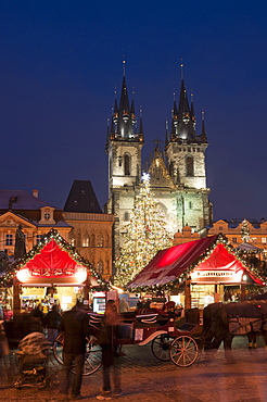 Horse drawn carriage at Christmas Market and Gothic Tyn Church at twilight, Old Town Square, Stare Mesto, Prague, Czech Republic, Europe