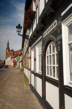 Historical Gothic style burgher houses along Kirchstrasse Street and Church of St. Stephan, Tangermunde, Saxony-Anhalt, Germany, Europe