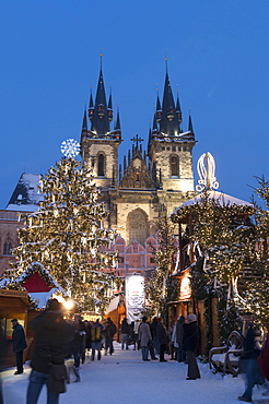 Snow-covered Christmas Market and Tyn Church, Old Town Square, Prague, Czech Republic, Europe 