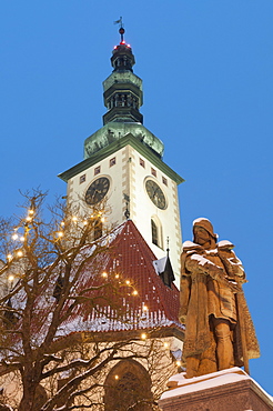 Snow-covered statue of Jan Zizka and Church of Transfiguration of Our Lady on Mount Tabor, Jihocesky, Czech Republic, Europe 