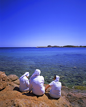 Three nuns sitting on rocks, Teulada, Sardinia, Italy, Europe