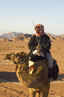 Bedouin on camel in the desert, Wadi Rum, Jordan, Middle East