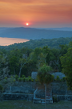 View of sunset over Lake Yaxha from Temple 216, Yaxha, Guatemala, Central America