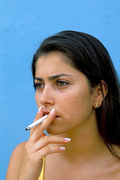 Portrait of a young woman smoking a cigarette, Genipabu (Natal), Rio Grande do Norte state, Brazil, South America