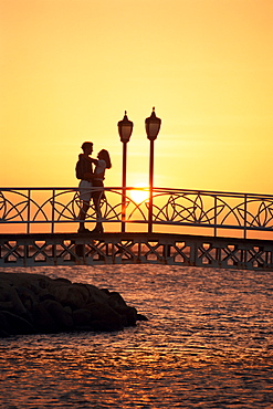 Couple on bridge at sunset, Aruba, West Indies, Dutch Caribbean, Central America