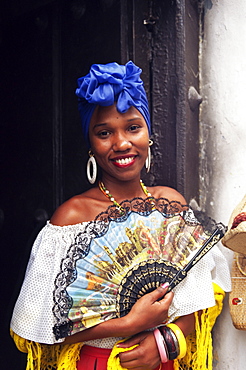 Young woman in typical Cuban dress holding a fan, Habana Vieja, Havana, Cuba, West Indies, Central America