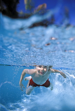 Little boy swimming underwater