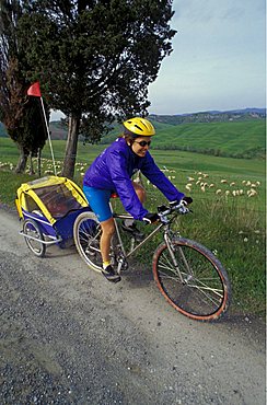 Bike with baby trailer in the country, Biking around Italy