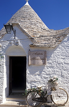 Bicycle leaned on a trullo, Alberobello, Puglia, Italy