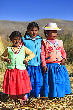 Children leaving on the Uros floating islands on Lake Titicaca, Puno, Peru