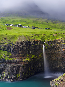 The waterfall near Gasadalur, one of the landmarks of Faroe Islands. The island Vagar, part of the Faroe Islands in the North Atlantic.  Europe, Northern Europe, Denmark, Faroe Islands