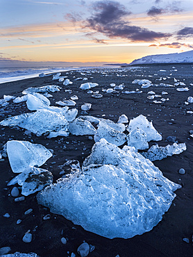 Iceberg on black vulcanic beach. North Atlantic beach of the ice lagoon Joekulsarlon at glacier Breithamerkurjoekull, Vatnajoekull NP. europe, northern europe, iceland, march