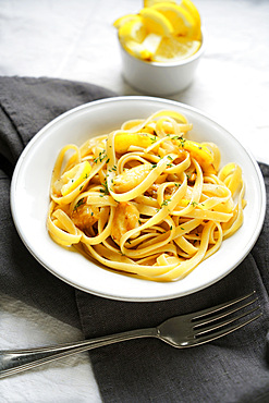 Traditional italian recipe, fettuccine pasta con limone e timo, topped with lemon and thyme, Italy, Europe