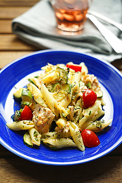 Pennette cold pasta with salmon, zucchini, cherry tomatoes and thyme