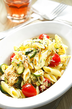 Pennette cold pasta with salmon, zucchini, cherry tomatoes and thyme