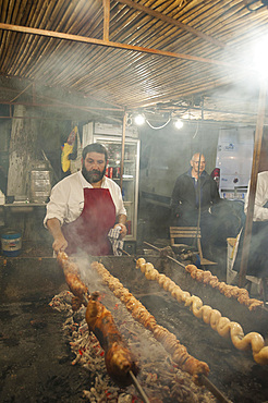 Porceddu, roast baby pork wrapped around a spit, Cordula made up of braided and cooked kid or lamb intestines wrapped around a spit, typical Sardinia recipe, Campidano, Sardinia, Italy, Europe