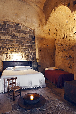 Bedroom of the hotel Le Grotte della Civita located in the Sassi di Matera that represents the almost paradigmatic expression of the Minor Historical Heritage, Matera, Basilicata, Italy, Europe