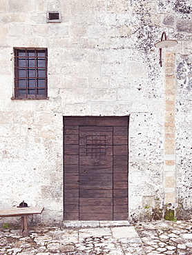 Ancient entrance gates to the cave houses in Matera into the Sassi. The Sassi di Matera are ancient cave dwellings in the Italian city of Matera, Basilicata. Situated in the old town, they are composed of the Sasso Caveoso and the later Sasso Barisano. Matera, Basilicata, Italy, Europe