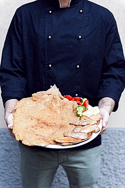 Cotoletta Milanese cooked by Restaurant Damm atra in Milano served with fried potatoes skind and tomatoes salad, Milan, Italy, Europe