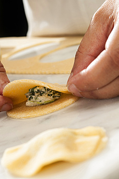 Making fresh tortelli by hand. Italy