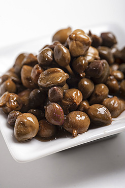 Sicilian capers in oil in a small white bowl, Sicily, Italy