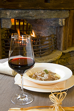 Mountain raviolo stuffed with polenta with a glass of red wine at Hotel Caprice des Neiges, Torgnon, Aosta, Italy