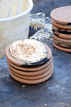 Panigaccio is a type of round, unleavened bread, baked in a special terracotta and mica dish, called testo, red-heated over high heat in a bonfire or in a wood-burning oven. A batter of flour, water and salt is interposed between one text and another, to form a pile. It is typical of the Lunigiana land on the border between Liguria and Tuscany, Italy, Europe